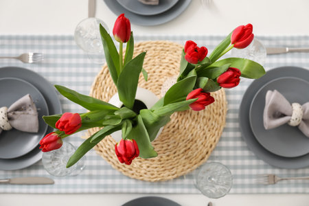 Setting for International Women's Day celebration with tulip flowers on tableの写真素材