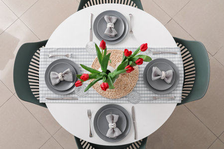 Setting for International Women's Day celebration with tulip flowers on table