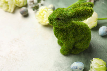 Easter bunny, tulip flowers and painted eggs on gray grunge background, closeupの写真素材