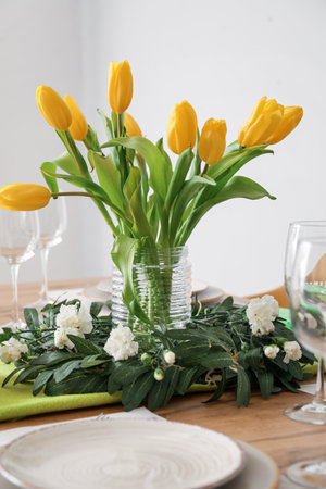 Setting for International Women's Day celebration with tulip and eustoma flowers on table