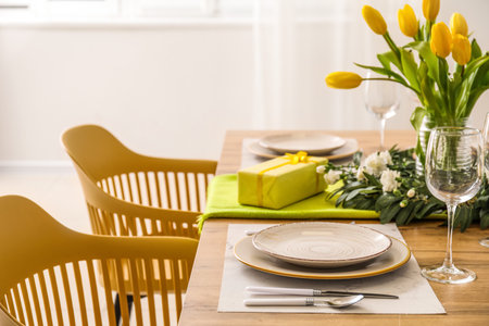 Table setting for International Women's Day celebration with gifts and tulip flowers in light room