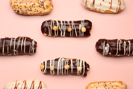 Many delicious eclairs on pink backgroundの写真素材