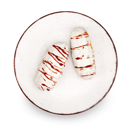 Plate with sweet eclairs isolated on white background