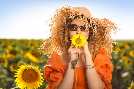 beautiful young woman in sunflower fieldの写真素材