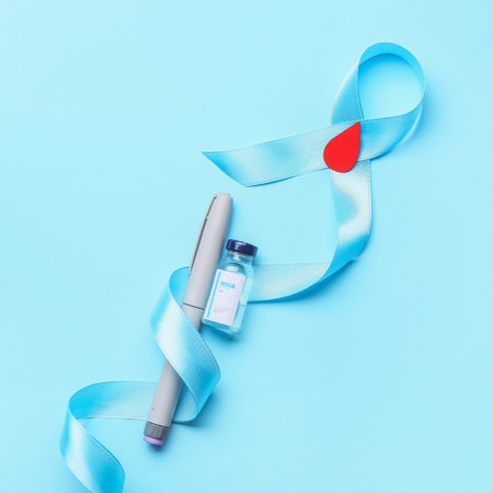 Awareness ribbon with insulin and syringe on color background. Diabetes conceptの写真素材