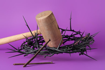Crown of thorns with mallet and nails on violet background. good friday conceptの写真素材