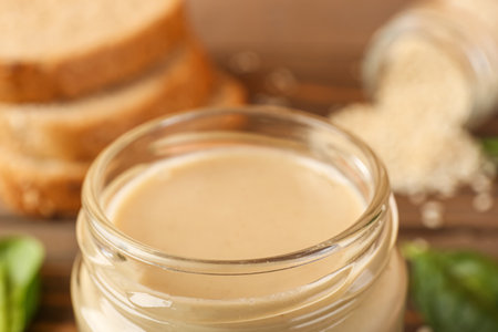 Glass jar of tasty tahini, closeup