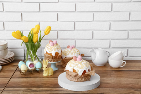 Easter cakes, tulip flowers and painted eggs on kitchen counter