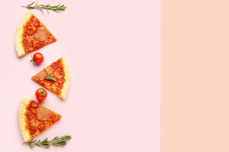 Composition with slices of delicious pepperoni pizza on pink backgroundの写真素材