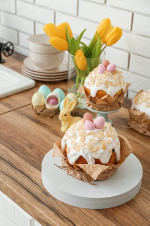 Easter cakes, tulip flowers and painted eggs on kitchen counter