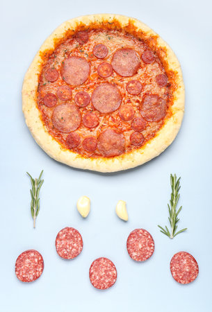 Composition with delicious pepperoni pizza and ingredients on blue backgroundの写真素材