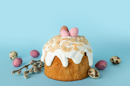 Easter cake, painted eggs and pussy willow branches on blue background