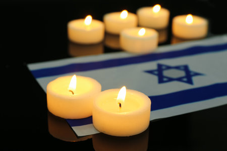 Burning candles with flag of Israel on dark background, closeup.の写真素材