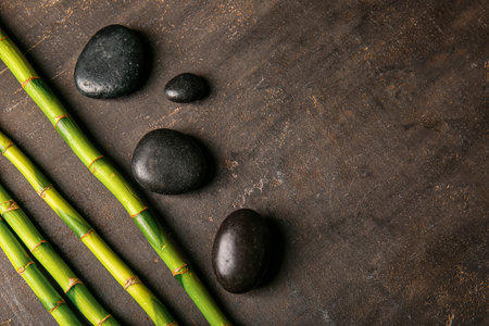 Spa stones and bamboo on dark background, top viewの写真素材