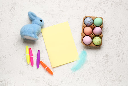 Blank card with Easter rabbit, eggs and markers on grunge backgroundの写真素材