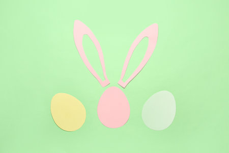 Paper bunny ears and Easter eggs on green backgroundの写真素材