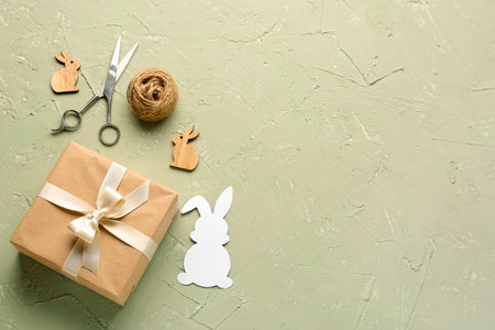 Gift with Easter rabbits, scissors and rope on grunge backgroundの写真素材