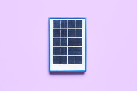 Portable solar panel on lilac backgroundの写真素材