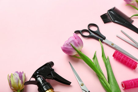Hairdresser's tools with tulips on pink background, closeup. hello springの写真素材