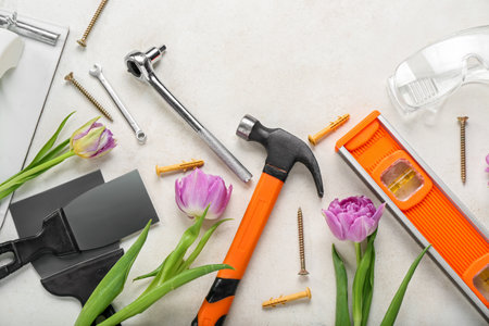 Builder's tools with tulips on white background. hello springの写真素材