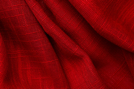 Close up view of crumpled red fabric as backgroundの写真素材