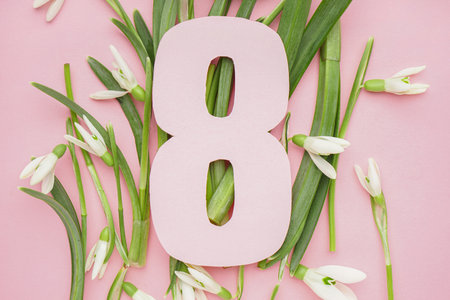 Beautiful snowdrops and number 8 on pink backgroundの写真素材