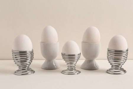 Easter eggs in holders on white backgroundの写真素材