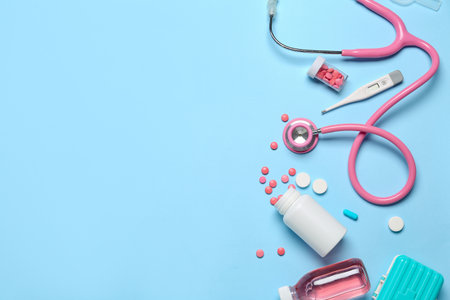 Stethoscope with thermometer and medications on blue background. world health dayの写真素材