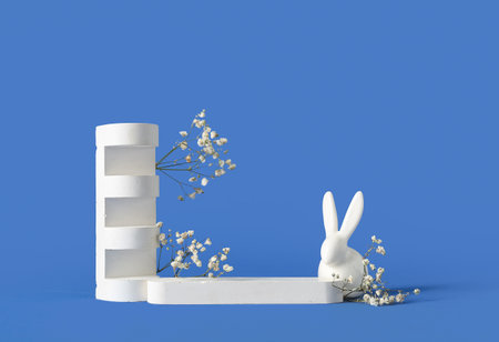Composition with podiums, Easter bunny and gypsophila flowers on color backgroundの写真素材