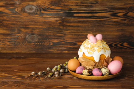 Easter cake with painted eggs and pussy willow branches on wooden background