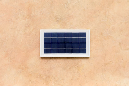 Portable solar panel on beige grunge backgroundの写真素材