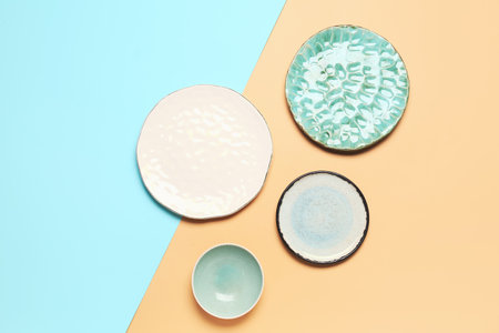 Composition with clean ceramic plates on blue and beige background