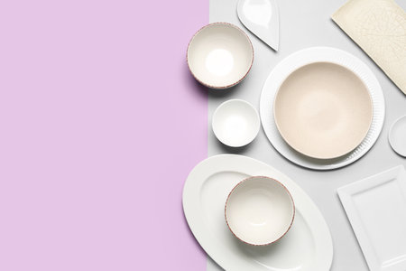 Composition with clean dishes on lilac and gray background