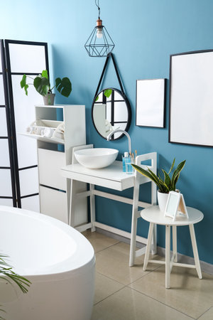 Interior of bathroom with sink, table and mirrorの写真素材