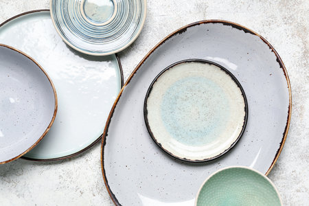Composition with clean ceramic plates on white background