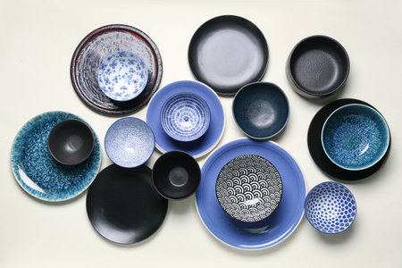 Composition with clean ceramic plates and bowls on white backgroundの写真素材