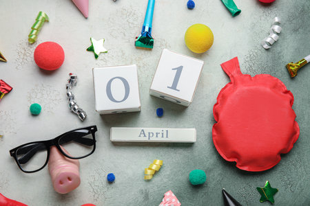 Date 1 APRIL with party decor for Fools' Day celebration on grunge backgroundの写真素材
