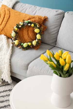 Easter wreath on sofa in living roomの写真素材