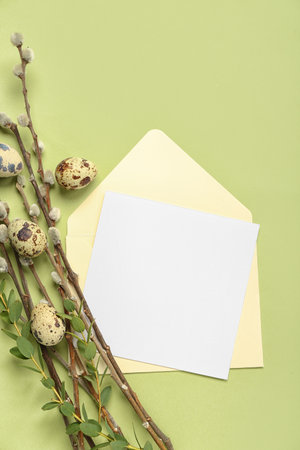 Blank greeting card, Easter eggs and plant branches on green backgroundの写真素材