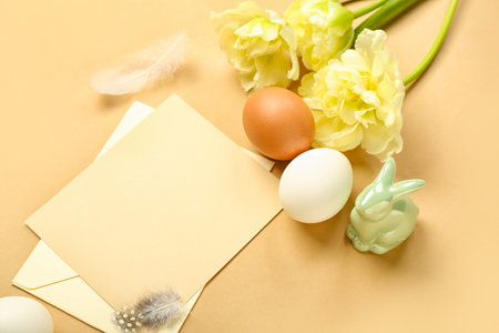 Blank greeting card, Easter eggs, bunny and tulip flowers on beige backgroundの写真素材