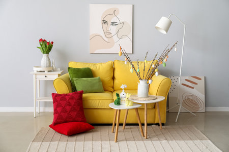 Interior of living room with Easter decor, yellow sofa and tablesの写真素材