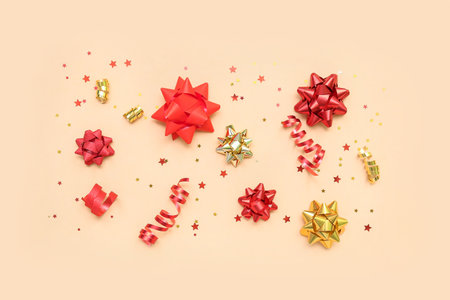 Beautiful bows made of ribbons and stars on beige background