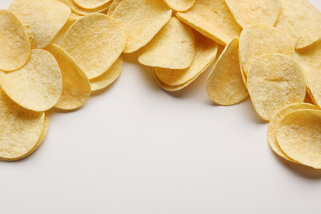 Frame made of delicious potato chips on white backgroundの写真素材