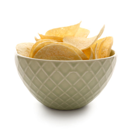 Bowl with delicious potato chips isolated on white backgroundの写真素材