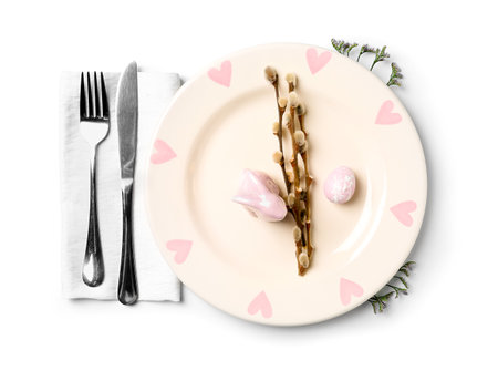 Beautiful table setting and willow branches on white backgroundの写真素材