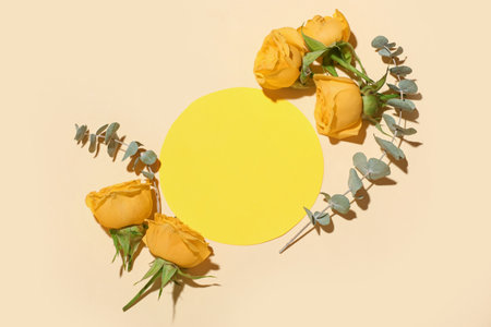 Blank greeting card, rose flowers and eucalyptus branches on beige backgroundの写真素材