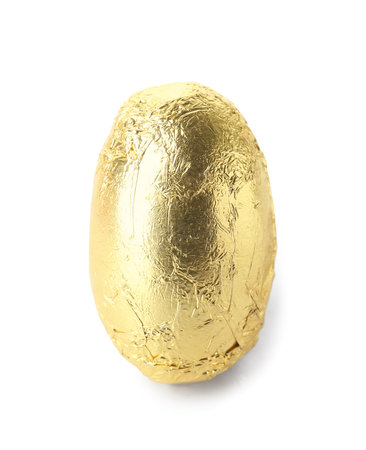 Easter egg in golden foil on white backgroundの写真素材