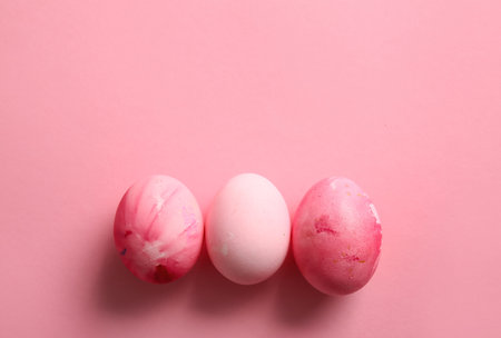 Beautiful painted Easter eggs on pink backgroundの写真素材