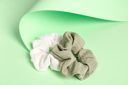 Stylish scrunchies on green backgroundの写真素材