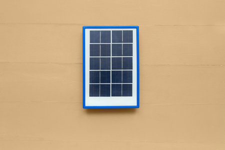 Portable solar panel on beige wooden backgroundの写真素材